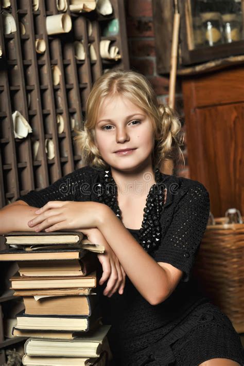 teen girl in retro style with a stack of books stock image