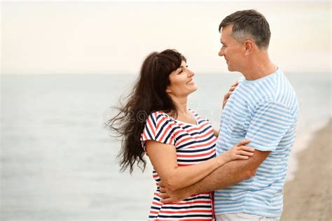 Happy Mature Couple Time Together On Sea Beach Space For Text Stock