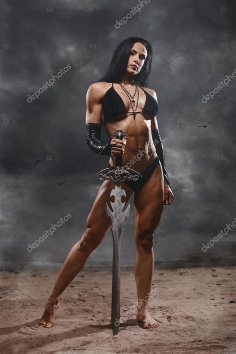 fantasy warrior woman with big sword in mystic landscape