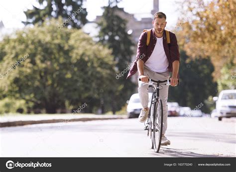 man riding bicycle stock photo  arturverkhovetskiy