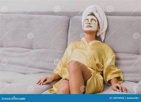 A Beautiful Young Woman Gets A Face Mask In The Spa Center Lying With
