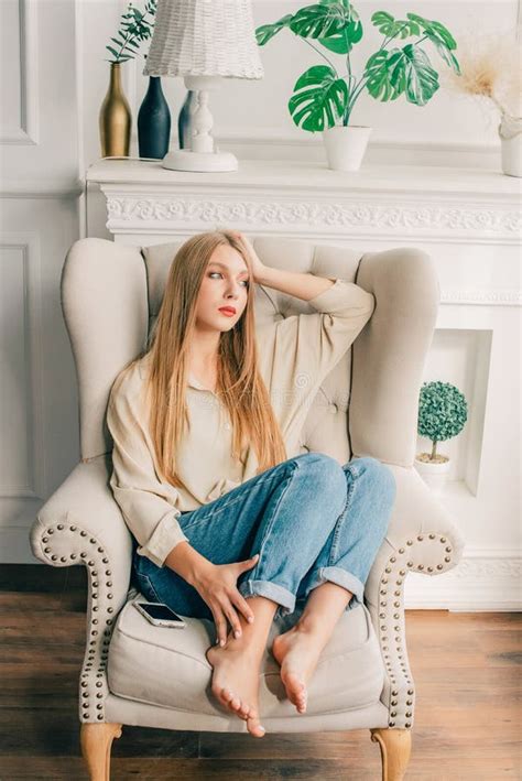beautiful woman sitting girl in a chair the blonde sat on a chair or