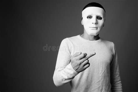 portrait  young man  white mask  gray background stock photo image  obscene