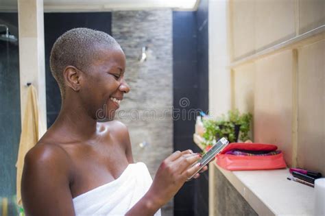 pretty girl on toilet with cell phone and smiling stock