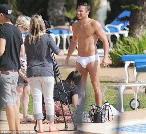 mark wright shows off his toned body as he poses in tight white pants