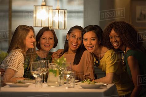 portrait smiling women friends dining  restaurant table stock photo dissolve
