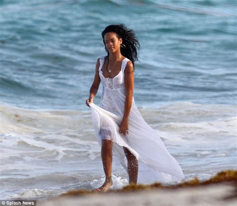rihanna smoulders on the beach as she becomes the official face of