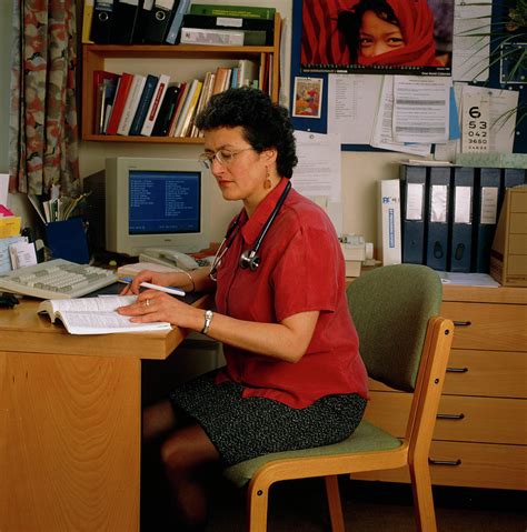 female gp doctor sitting working   desk photograph  claire paxton jacqui farrowscience