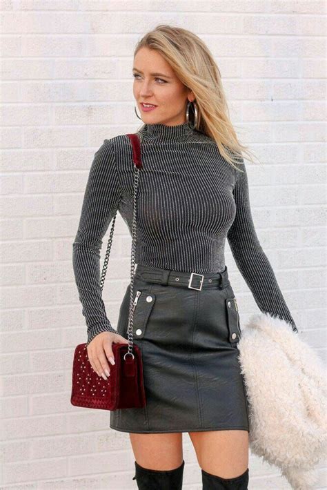 blonde in ribbed charcoal sweater and belted black leather skirt leather skirt black leather