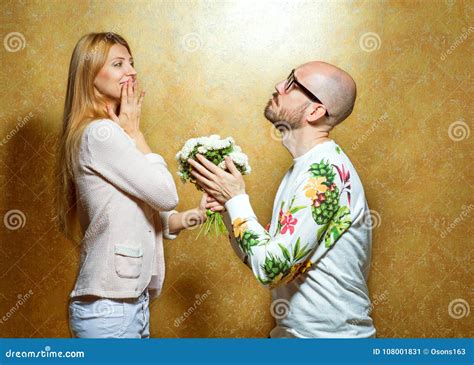 Emotional Fashion Couple Give Each Other Flowers On Valentine`s Stock