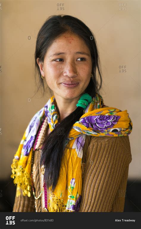 a pretty nepali girl from a small village smiling and looking away