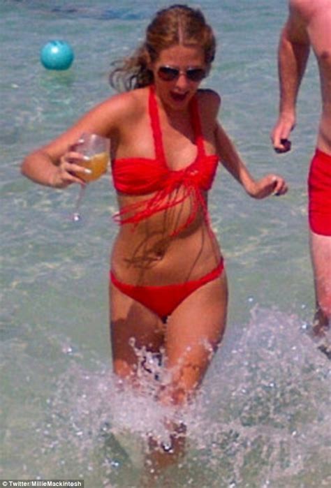 millie mackintosh jogs through the sea in a bright red
