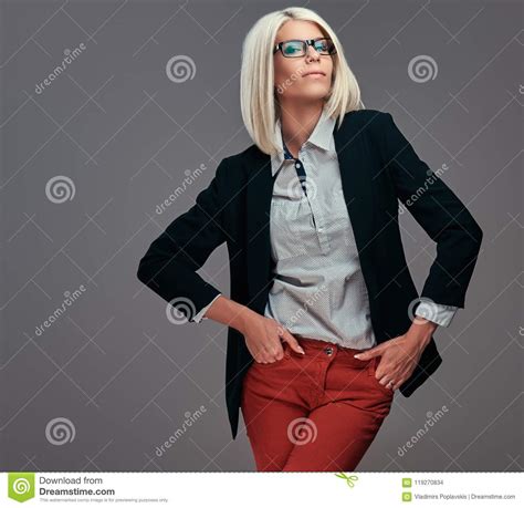fashion blonde woman in trendy clothes and glasses posing