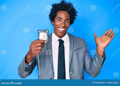Handsome African American Man With Afro Hair Holding Detective Badge