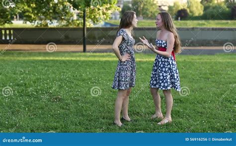 Two Pretty Girlfriend Standing In A Park Talking Stock Footage Video