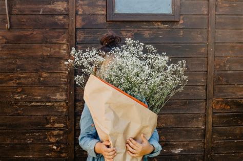 photo girl hiding face  bouquet