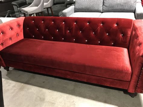 red velvet upholstered jeweled sofa