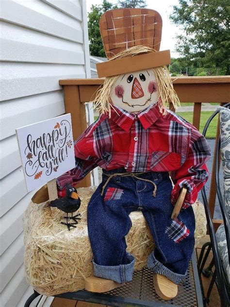 scarecrow sitting  top   hay bale