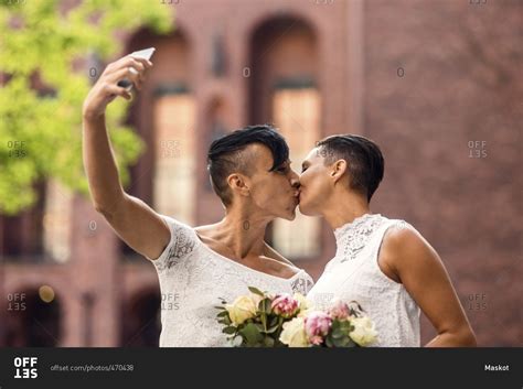 Lesbian Couple Taking Selfie From Mobile Phone While Kissing Stock