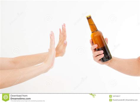 Female Hand Reject A Bottle Of Beer Isolated On White