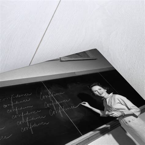 1950s Teacher In Front Of Classroom Writing Confidence On Blackboard