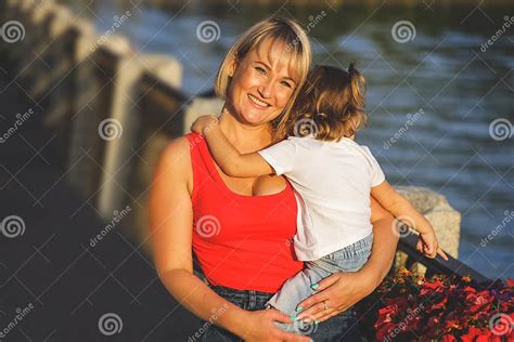 beautiful blonde mom in a red t shirt with her daughter group portrait