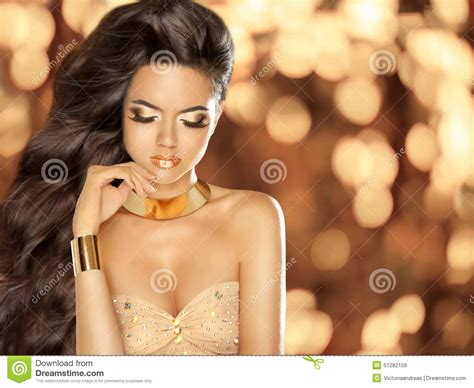 Fashion Beautiful Girl With Long Wavy Hair Wearing In Golden Stock