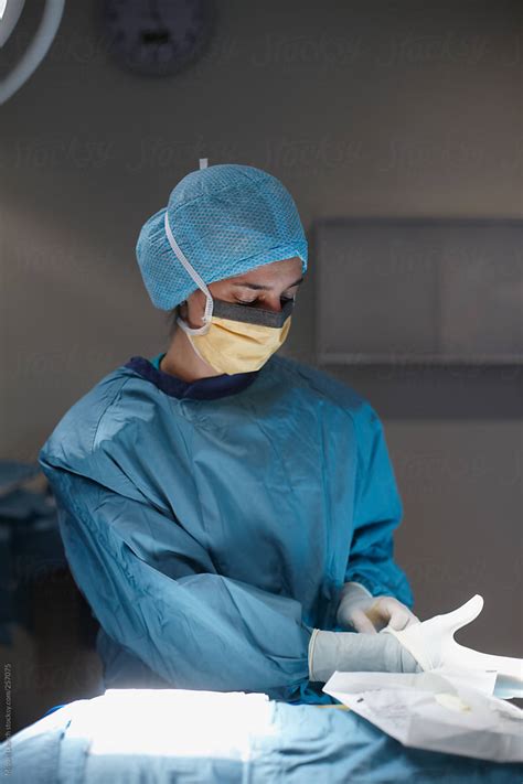 female surgeon putting  surgical gloves  stocksy contributor