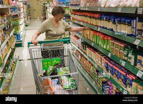 older woman shopping in open cor supermarket torremolinos malaga