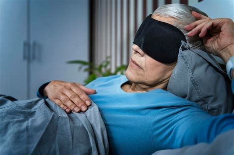 Premium Photo Mature Woman Wearing Black Sleep Mask Lying In Bed