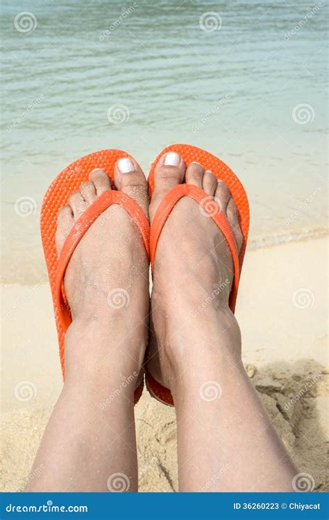 feet wearing orange flip flop   beach  stock image image  tropics water