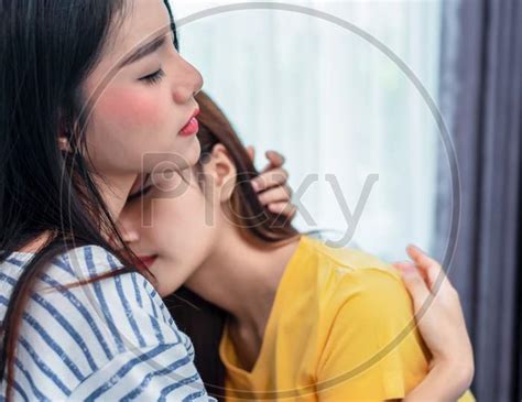 Image Of Close Up Of Two Asian Lesbian Women Looking Together In
