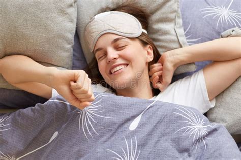 Portrait Of Happy Joyful Cheerful Woman Lying In Bed Stretching Her