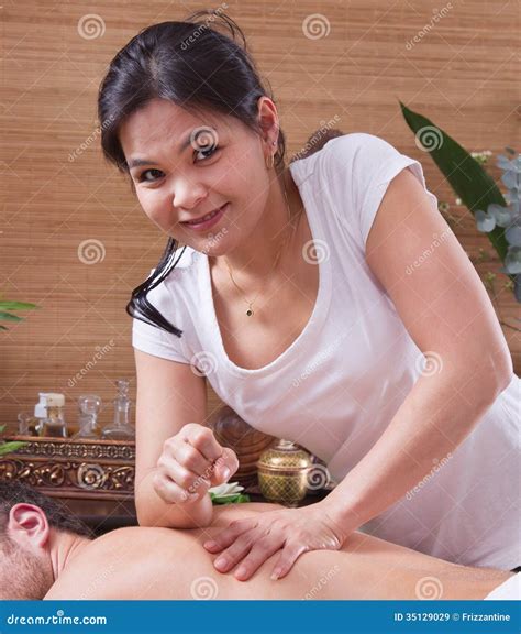 asian woman making massage to a man royalty free stock images image
