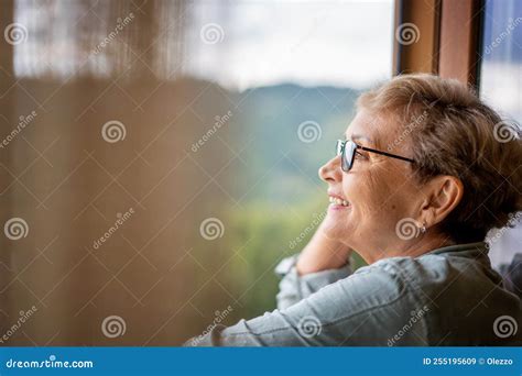 Portrait Of A Happy Senior Beautiful Mature Woman In Glasses Standing