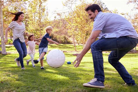 family playing soccer  park  stock photo dissolve