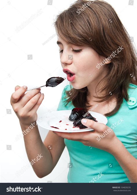 funny teen girl eating charlotte on the white background
