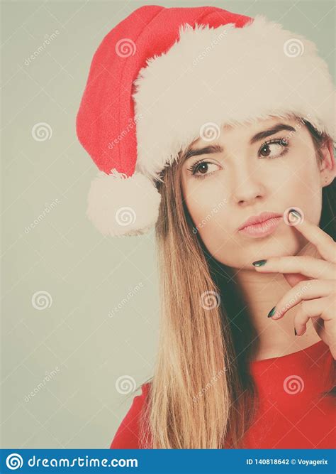 thinking woman wearing santa claus helper costume stock photo image