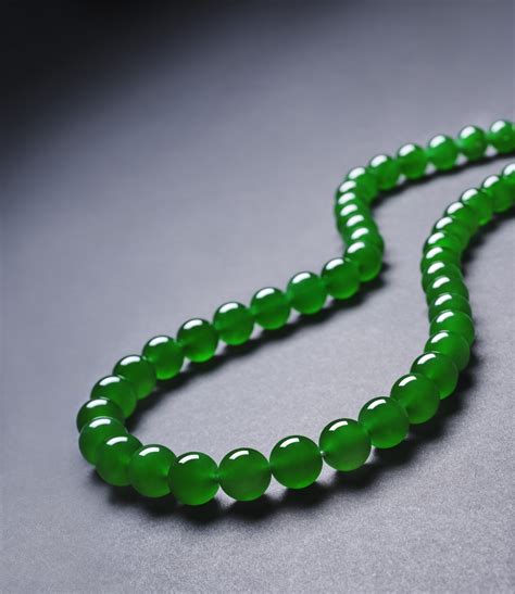 an extremely rare and exceptional “imperial green” jadeite bead and