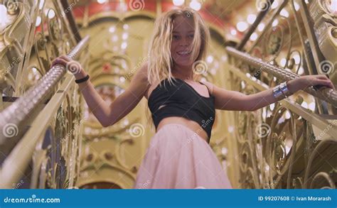 Attractive Blonde Girl Looks At The Camera Smiling Dancing Fooling