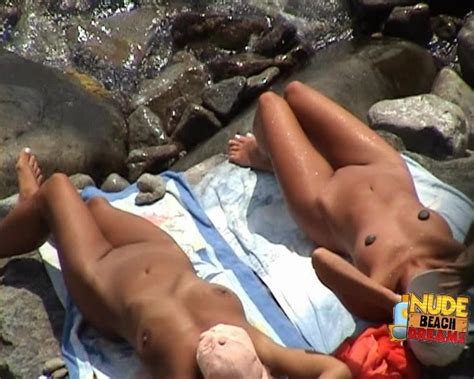 nice lesbian couple spends their time naked on the beach