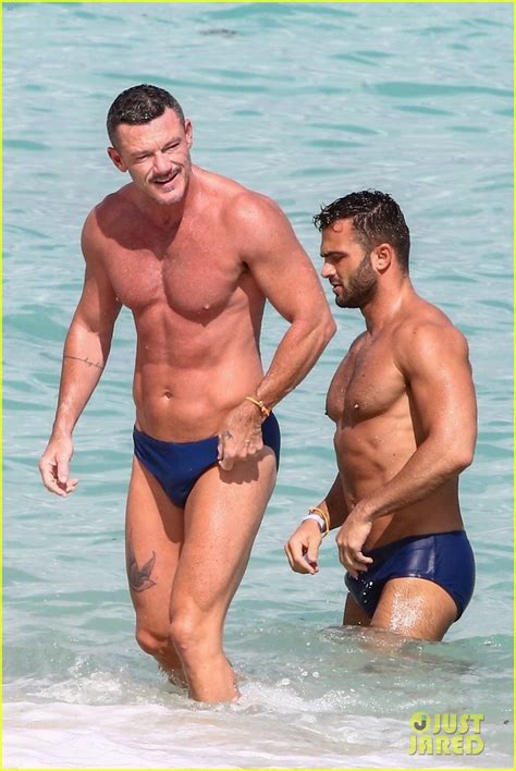 luke evans shows off his buff bod at the beach with a