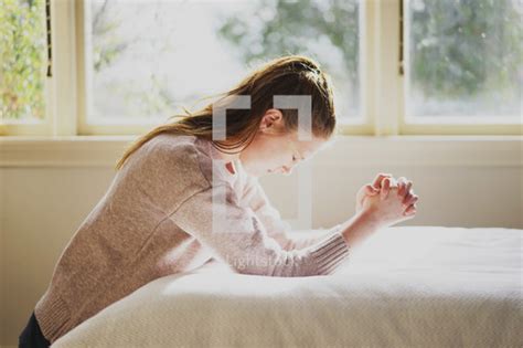 A Woman Kneeling In Prayer By Her Bed — Photo — Lightstock