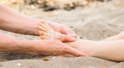 Foot Massage On A Beach In Sand Male And Female Caucasian Stock