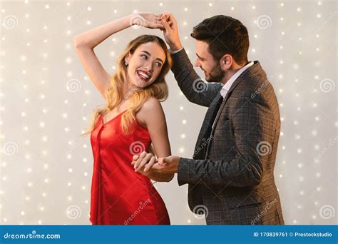 cheerful romantic couple dancing   date  restaurant stock
