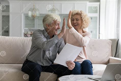 Excited Cheerful Mature Older Couple Giving High Vive Clapping Hands
