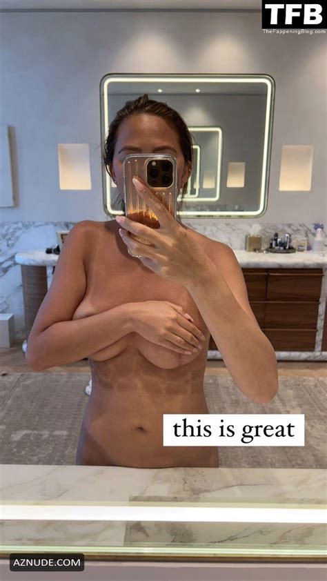 chrissy teigen sexy poses topless showing off her nude tits in a mirror