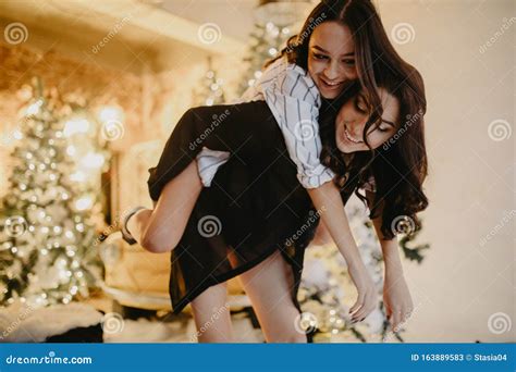 Lesbian Couple Has A Fun Against Background Of Christmas Decorations