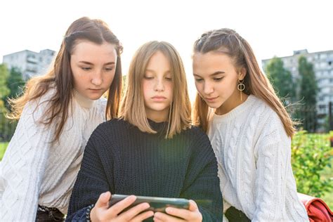 three girls schoolgirls teenagers 1315 years old fall day summer city