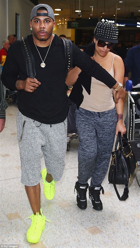nelly keeps his muscular arm around girlfriend shantel jackson as he
